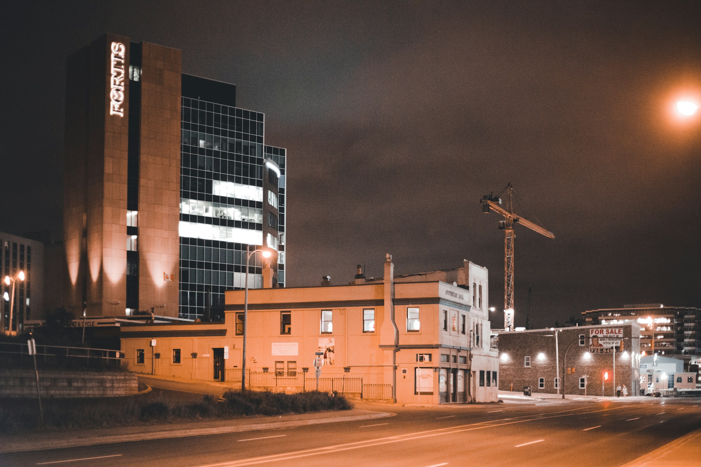 Historic building and construction crane at night, a symbol of building something new